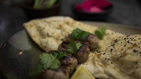 The go-to dish: sheftalia caul-wrapped sausage with lemon and pita. 