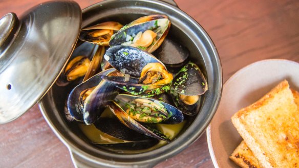 Mussels in white wine demand hot-buttered bread and a glass of something cold.