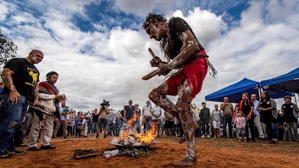 Fire and smoke are the companions of the 105 repatriated ancestors throughout their journey back to country. Mutthi Mutthi elder David Edwards performs a ceremonial dance at Balranald, NSW.