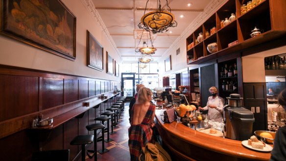 Handsome timber panelling and gold-framed paintings decorate the Grossi family's Cellar Bar.