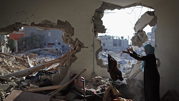 Islam al-Masri sorts through the rubble of her destroyed home in the Gaza Strip town of Beit Hanoun in August of last year.