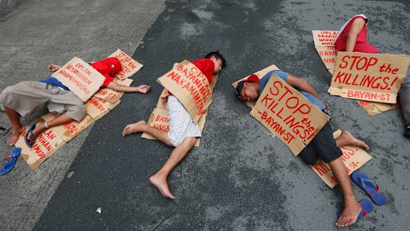 People stage a "die-in" to protest the rising number of extra judicial killings related to Philippine President Rodrigo Duterte's "War on Drugs".