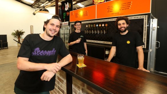 Matt King (right) with mates Trent Evans (left) and Glenn Wignall in their Marrickville brewery, The Grifter Brewing Co.