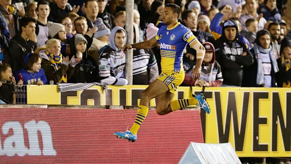 On the hop: Bevan French celebrates scoring a try against Cronulla Sharks in round 17.