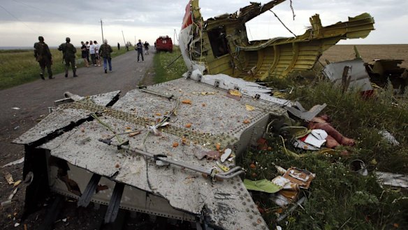 Locals gather near part of the MH17 wreckage near the settlement of Grabovo.