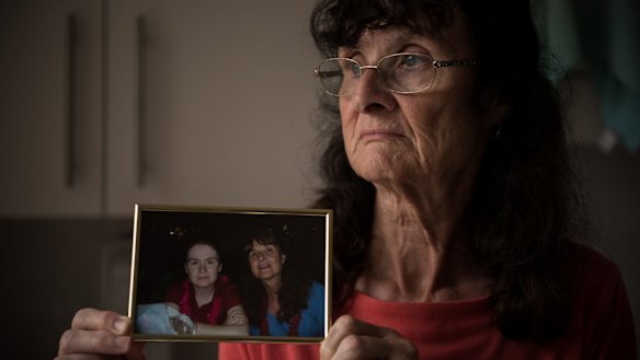 Maureen McIlquham holds a photo of herself and her daughter, Michelle, who died of meningitis in 2009. 