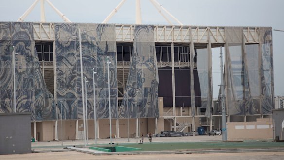 The translucent tapestries created by Brazilian artist Adriana Varejao fall from the exterior of the aquatic stadium in February.