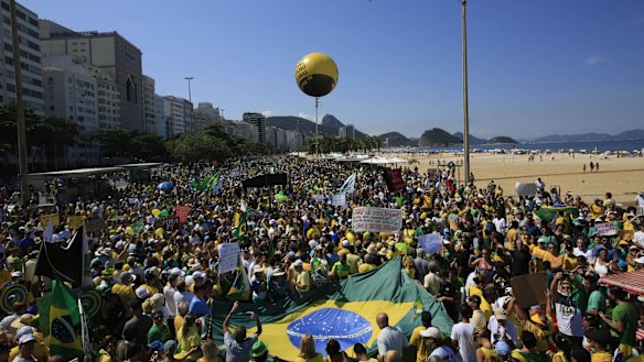 Demonstrators gather on Copacabana beach during a protest in Rio de Janeiro, Brazil, on Sunday. Similar crowds are estimated at 1 to 2 million during New Year's Eve festivities.