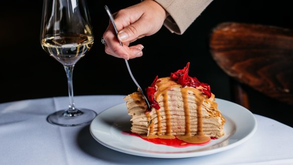 The 15-layer crepe cake with dulce de leche cream and rosella flowers.