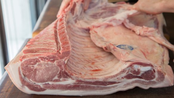 A pork loin (left) connected to a slab of baby back ribs.