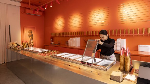 The sleek ice-cream parlour is decorated in red, white and shiny grey.