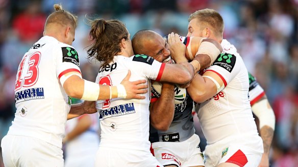 Crunch: Roosters forward Sam Moa is tackled by the St George Illawarra Dragons at Allianz Stadium.