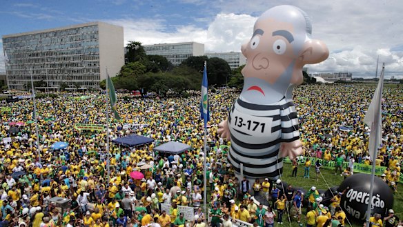 Thousands of demonstrators demand President Dilma Rousseff's impeachment in Brasilia on Sunday where a large inflatable doll depicts former president Luiz Inacio Lula da Silva in prison garb.