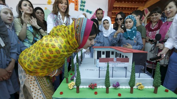 Malala Yousafzai blows out candles on her birthday cake at a school for Syrian refugee girls, built by the NGO Kayany Foundation, in Lebanon's Bekaa Valley.