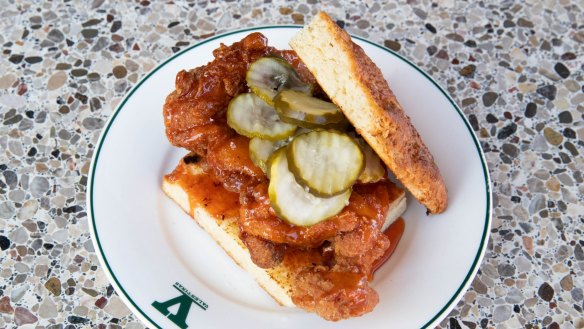 Fried chicken sandwich with deep-fried meat, hot honey butter and crinkle-cut pickles.