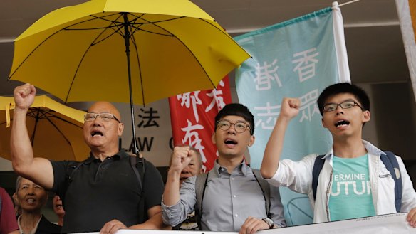 From left, lawmaker Albert Chan and pro-democracy leaders Nathan Law and Joshua Wong last year after Wong was acquitted of obstructing police at a 2014 protest.