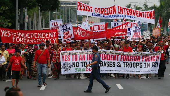 Protesters reject US troops in the Philippines in Manila on Wednesday. But how will the wider population of the Philippines greet the president's new direction?
