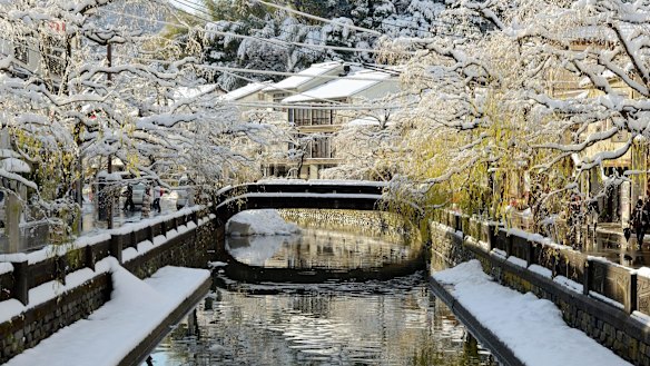 A bridge in Kinosaki Onsen covered by snow.