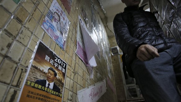 A man walks down the stairs of the closed Causeway Bay Bookstore which are known for gossipy titles about Chinese political scandals.