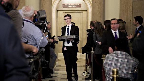 Food trays are walked out of the office of US House Speaker Paul Ryan as Republicans mulled the deal first authored by Ryan.