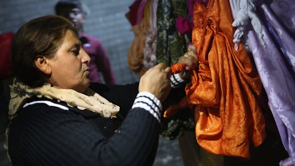 A Yazidi woman ties a knot in a scarf last week, as a way to make a wish in the temple of Lalis, in Lalish, Nineveh Province, Iraq.