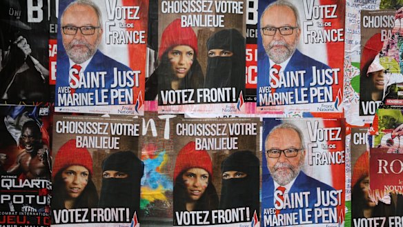 Posters for far right anti-immigration party National Front state in Paris earlier this month.