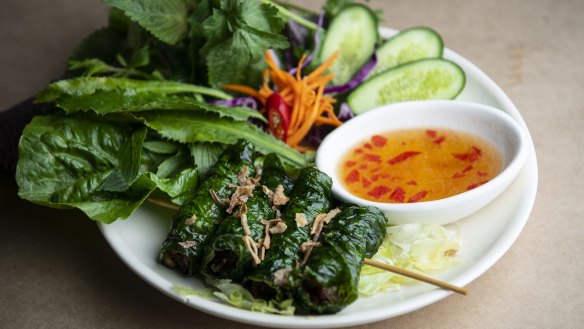 Bo la lot (grilled betel leaf rolls stuffed with minced beef) with nuoc cham.