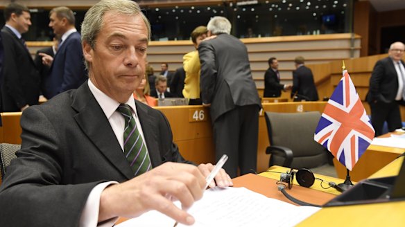 UKIP leader Nigel Farage sits next to a British flag during a special session of the European Parliament on June 28.