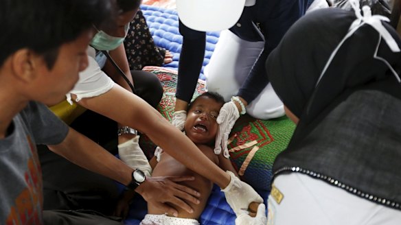 A Rohingya child, who arrived in Indonesia this week by boat, receives medical treatment for an eye infection at a temporary shelter near Langsa in Indonesia's Aceh Province.