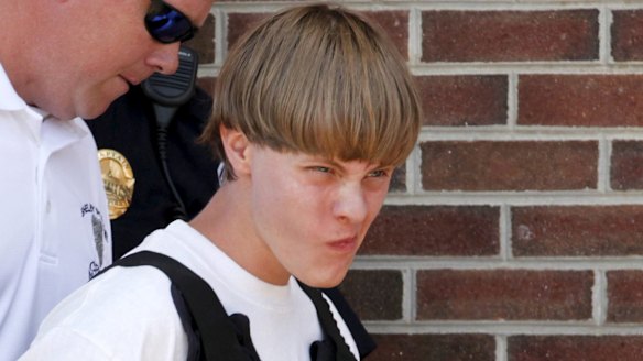 Police lead suspected shooter Dylann Roof, 21, into the courthouse in Shelby, North Carolina.
