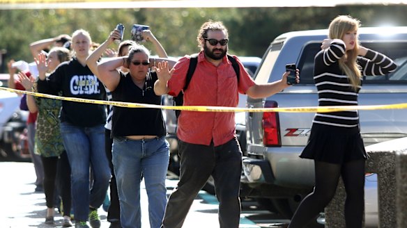 Students, staff and faculty are evacuated from Umpqua Community College in Roseburg on Thursday. 