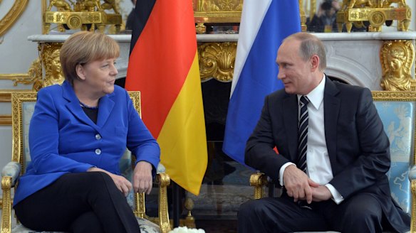 German Chancellor Angela Merkel listens to Russian President Vladimir Putin, right, at the Elysee Palace in Paris on Friday.