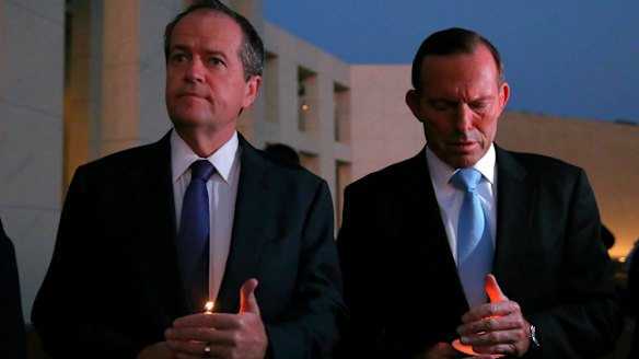 Opposition Leader Bill Shorten and Prime Minister Tony Abbott during a candlelight vigil in February.