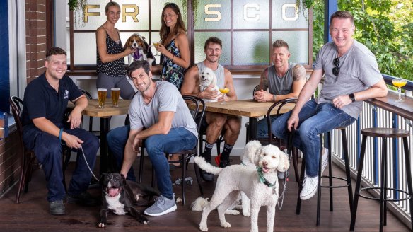 Vaucluse trainer Mike Webster (front centre) with Bobby the shelter dog. The Strut with Mutts is a chance for the dogs to escape the cage and raise money for the Animal Welfare League. 