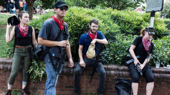 A group of Antifa activists rest during a rally in Charlottesville, Virginia. 
