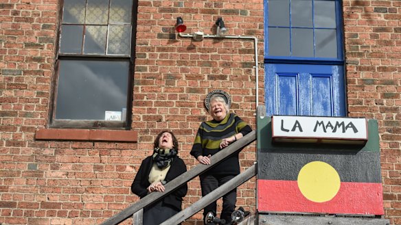 Caitlin Dullard and Liz Jones enjoy a laugh on the theatre steps.
