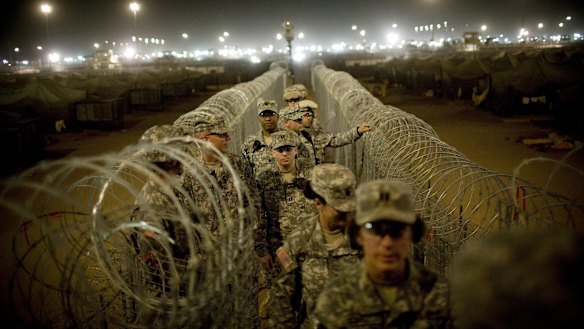 US soldiers patrol Camp Bucca, near the Iraq-Kuwait border, in 2008.