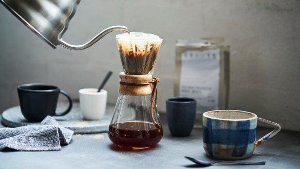 Preparing a filter coffee using the pourover method with a Chemex flask and gooseneck kettle.