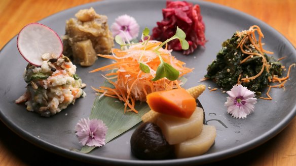 The vegetable platter includes yuzu pickles, miso eggplant and sesame kale.
