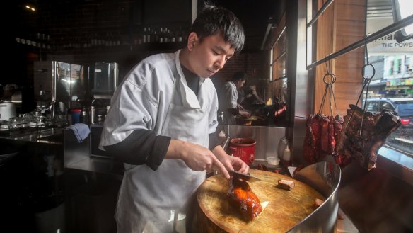 Roasted ducks and barbecued meats hang in the window of Yu Chu.