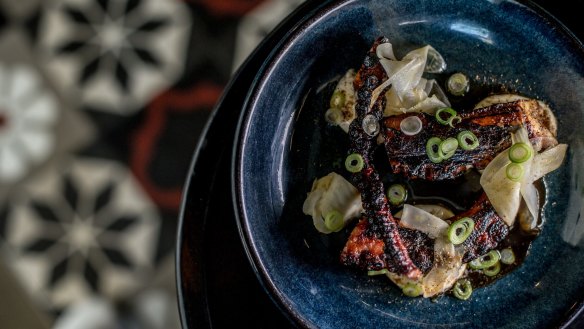 Char-grilled octopus with pickled cabbage.