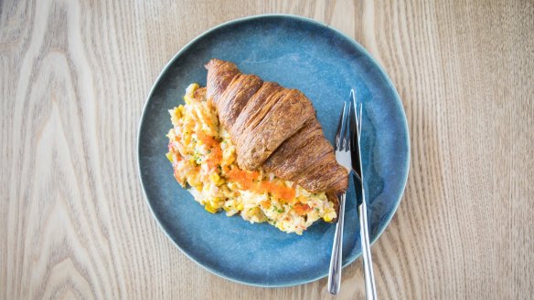 Toasted croissants with soft scrambled eggs, crabmeat and corn.