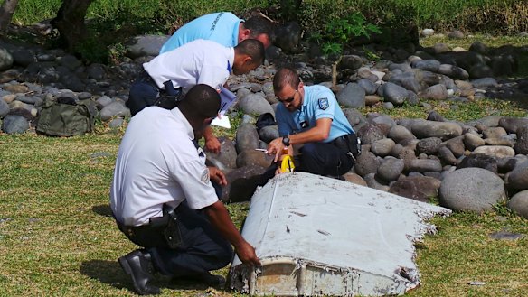 French police inspect the flaperon, now confirmed to be from MH370, on Reunion Island.