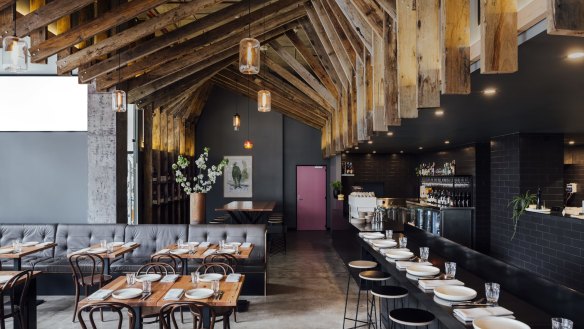 The 50-seat dining room is framed by angular beams of recycled public-housing timber.