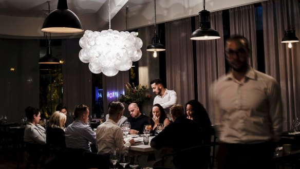 A cloud-shaped chandelier casts bubbly shadows on the ceiling.