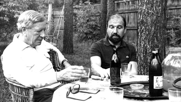 Kim Philby (left) and George Blake talk over a bottle of wine, July 1979.