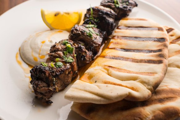 Skewered lamb rump with grilled flatbread and a squeeze of lemon.