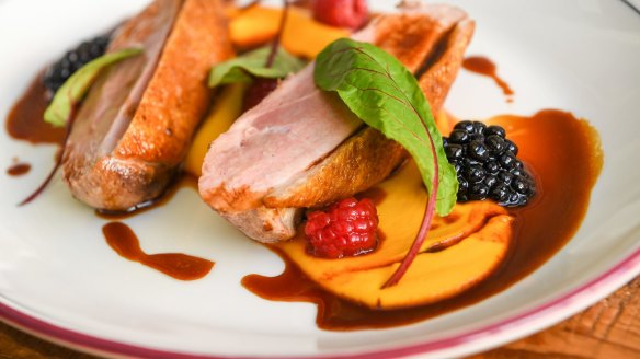 Hay-smoked duck breast with carrot puree and berries.