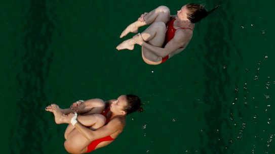 "It's so green": United States' Amy Cozad, top, and Jessica Parratto before diving into the green pool.
