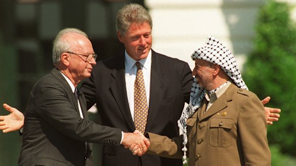 US president Bill Clinton with Rabin and Palestine Liberation Organisation chairman Yasser Arafat mark the signing of the first Oslo peace accord with a handshake at the White House in September 1993.